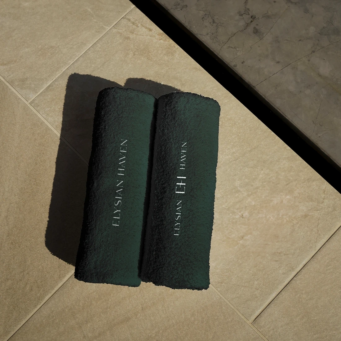Two embroidered Elysian Haven towels