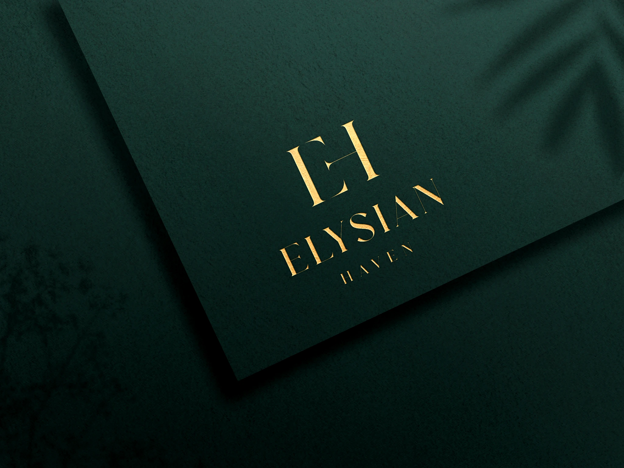 Gold-coloured Elysian Haven logo on a forest-green envelope