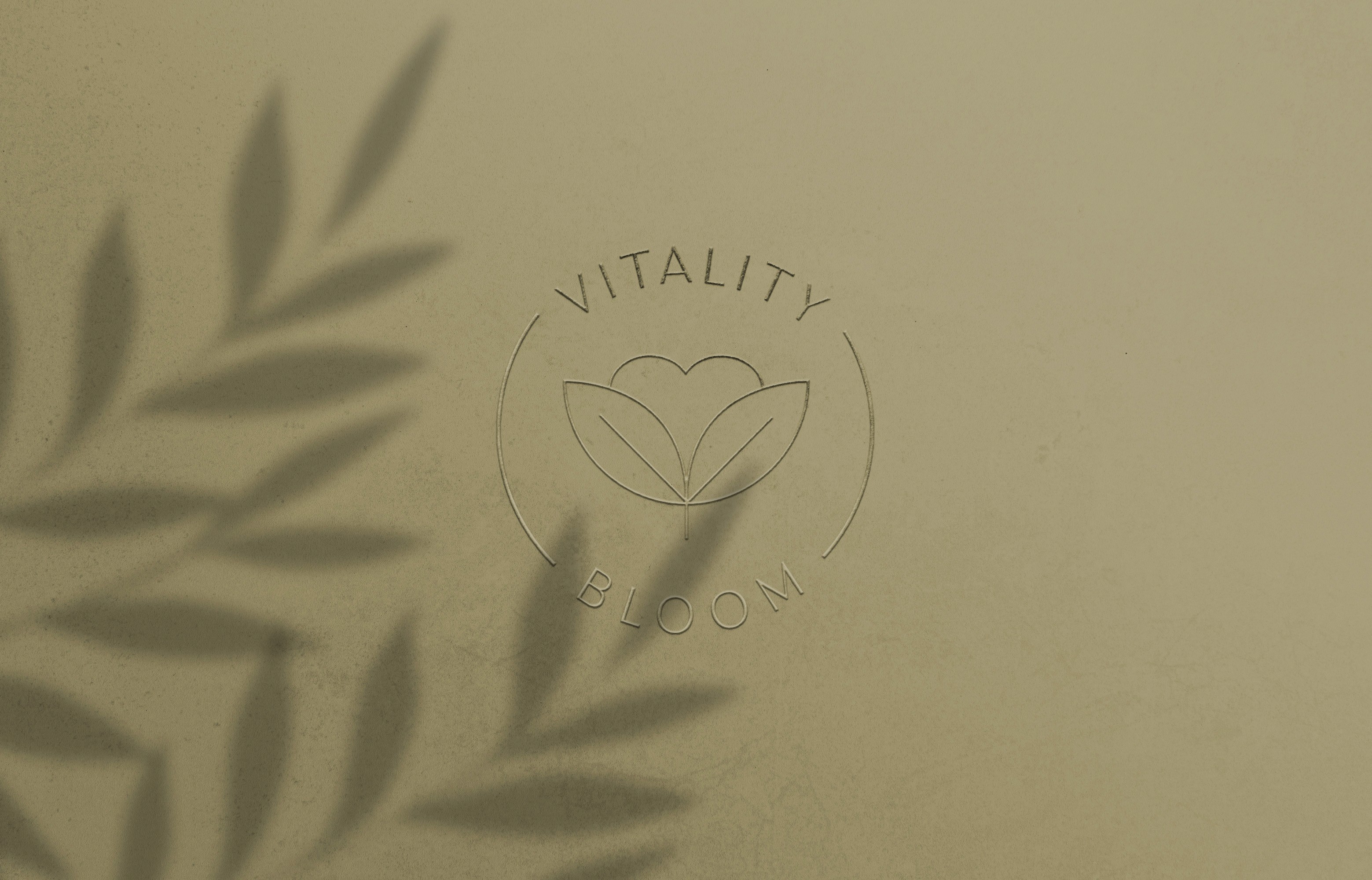 Vitality Bloom logo embossed on an olive paper surface with soft leaf shadows