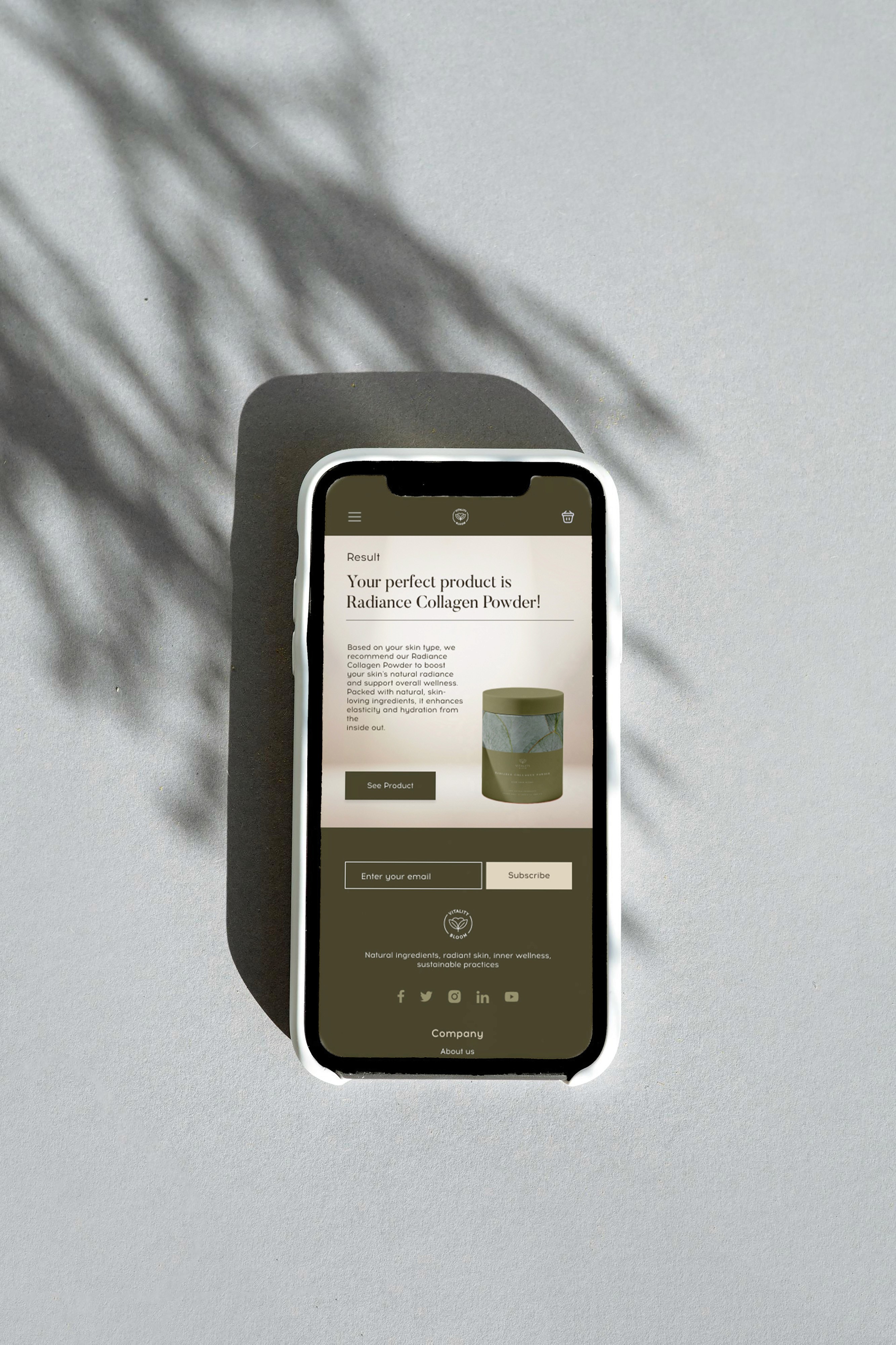 Vitality Bloom mobile website concept on a phone resting on a grey surface